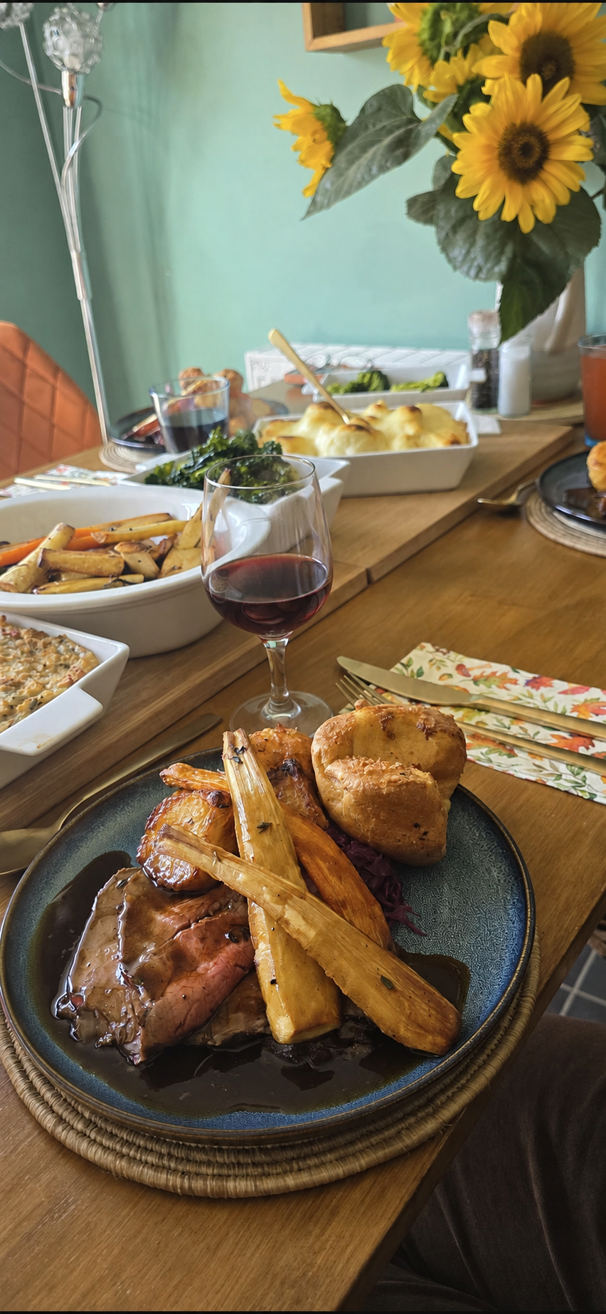 Roast beef, Yorkshire pudding and roast vegetables at a family table